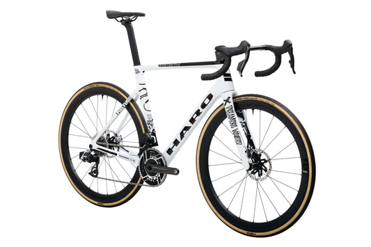 Haro Bikes Partimos Carbon Custom "Black Sheep" road bike with drop bars, tan tires, rear view, on white background.