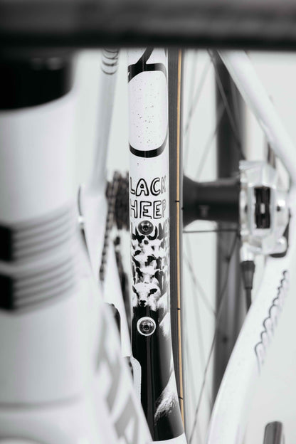 Close-up of a Haro Bikes Partimos Carbon Custom "Black Sheep" frame, sheep graphic partly obscured by bike components.