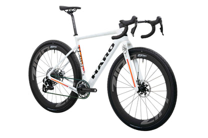 Buzzard Carbon Custom “Desert Sunset” by Haro Bikes: white gravel bike with drop bars and black Zipp wheels on white background.