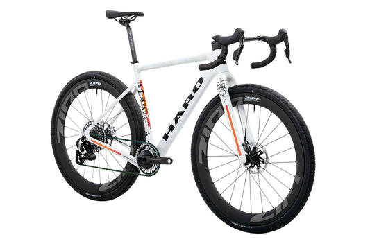 Buzzard Carbon Custom “Desert Sunset” by Haro Bikes: white gravel bike with drop bars and black Zipp wheels on white background.
