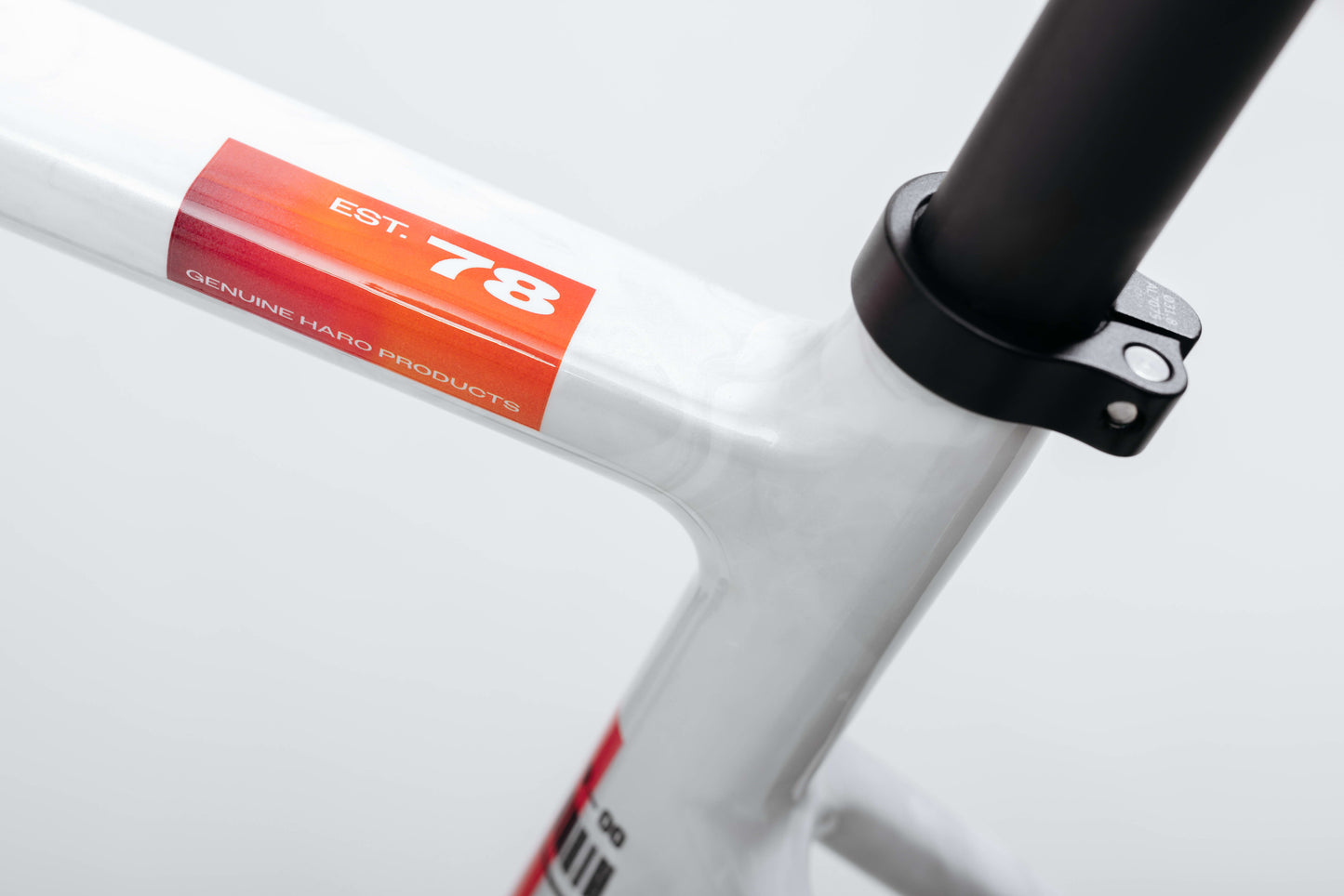 Close-up of a Haro Bikes Buzzard Carbon Custom “Desert Sunset” frame with a red EST. 78 sticker near the seat post clamp.