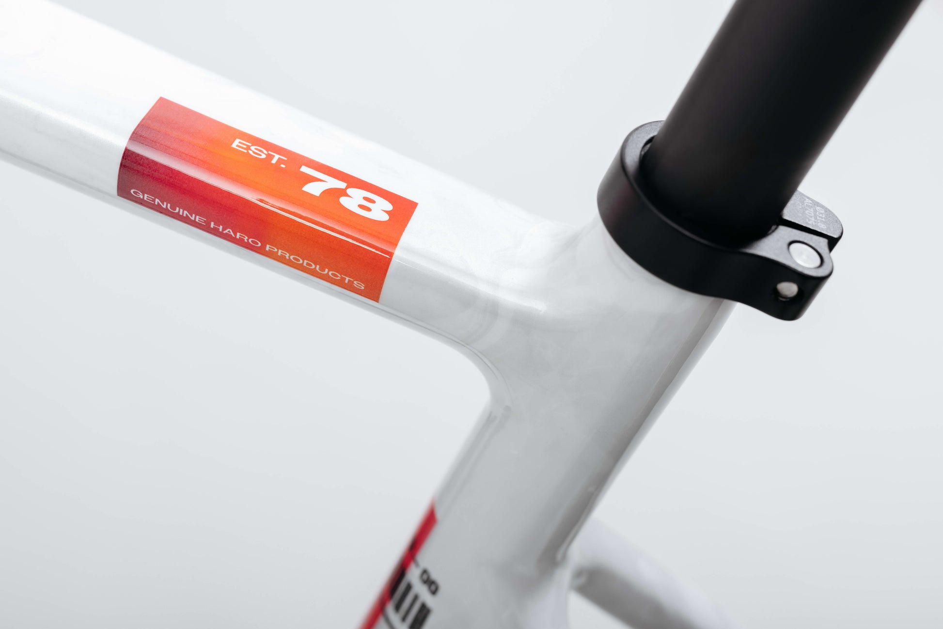 Close-up of a Haro Bikes Buzzard Carbon Custom “Desert Sunset” frame with a red EST. 78 sticker near the seat post clamp.