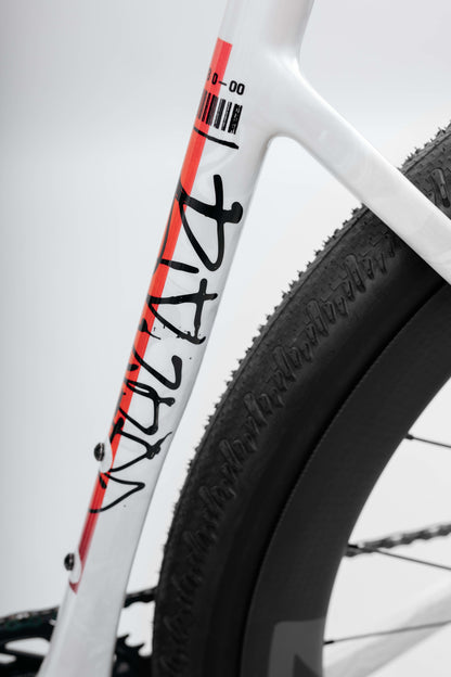 Close-up of a Buzzard Carbon Custom “Desert Sunset” frame by Haro Bikes with a large rear tire—ideal for Gravel Bike fans.