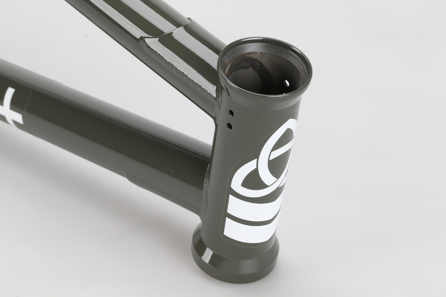 Close-up of a matte dark green Haro Bikes "Dennis Enarson SD" V3 4130 Chromoly BMX frame with white graphics and integrated headset.