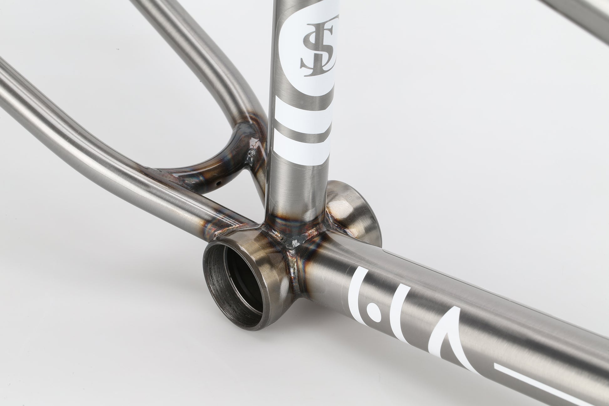 Close-up of a Haro Bikes "Dennis Enarson SD" V3 4130 Chromoly BMX frame with visible welds and white graphics on a white background.
