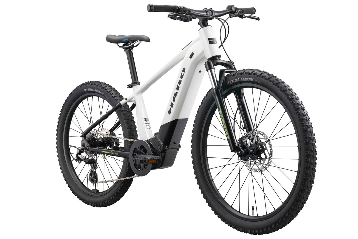 Haro Bikes eKids I/O 24/26: White youth e-bike with thick tires, disc brakes, black seat, and Bosch Performance Line SX Motor.