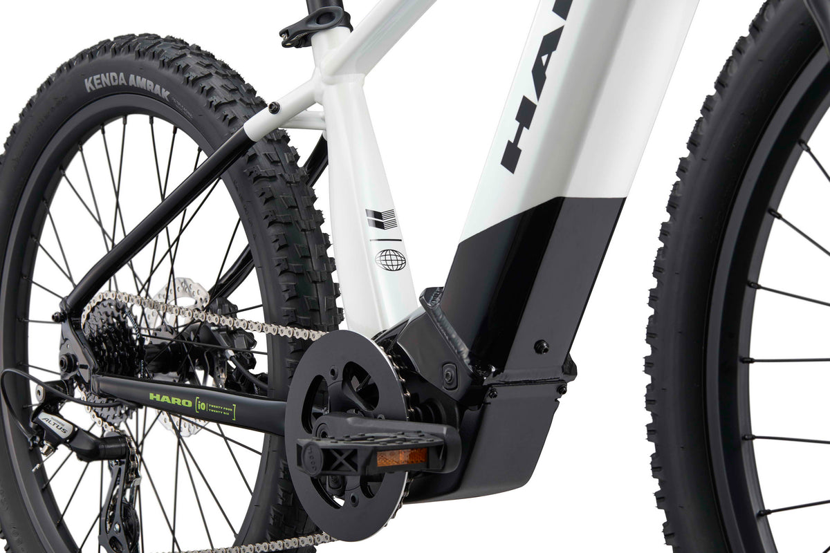 Close-up of a Haro Bikes eKids I/O 24/26 electric mountain bike, Bosch Performance Line SX motor, frame, chain, pedal, rear wheel.