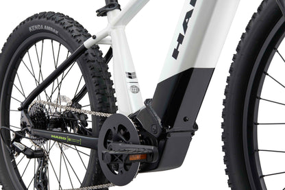 Close-up of a Haro Bikes eKids I/O 24/26 electric mountain bike, Bosch Performance Line SX motor, frame, chain, pedal, rear wheel.