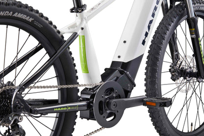 Close-up of the drivetrain and frame of a white Haro Bikes eKids I/O 24/26 with thick treaded tires and Bosch Performance Line SX Motor.