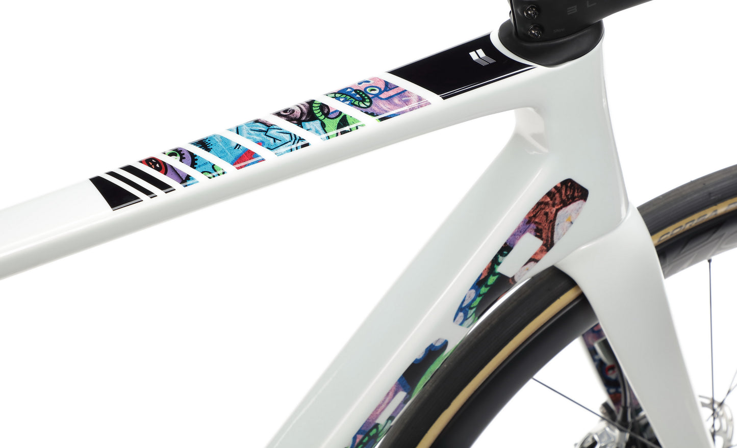 A close-up of the Haro Bikes Rivette Carbon EP Edition frame shows colorful abstract stickers with various patterns on the top tube.