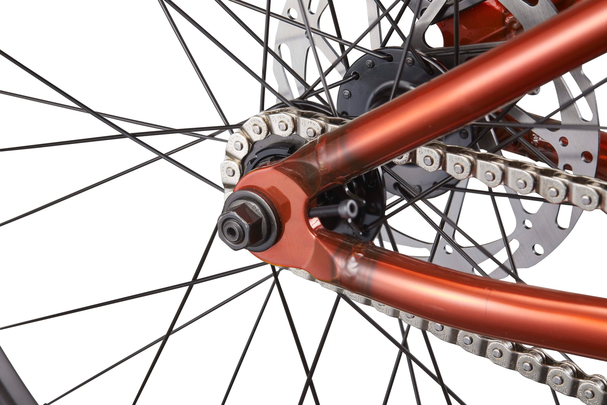 Close-up of a HARO Steel Reserve TS rear wheel with spokes, chain, disc brake, and orange frame on a white background.