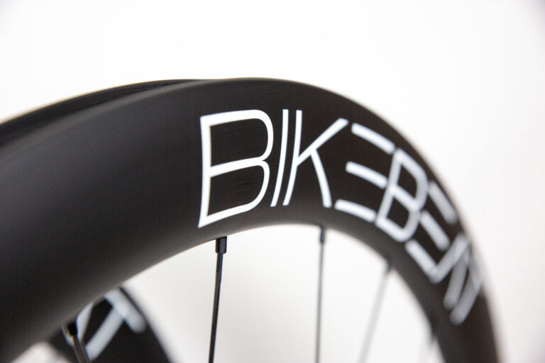 Black carbon fiber Bike Beat Überflieger Pro 50 Disc wheelset with white branding text on a white background.