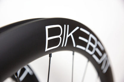 Black carbon fiber Bike Beat Überflieger Pro 50 Disc wheelset with white branding text on a white background.