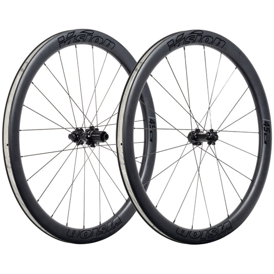A pair of Haro Bikes Wheelset Road Built Kit Vision SC 45, carbon disc wheels with deep rims and thin spokes, standing upright.